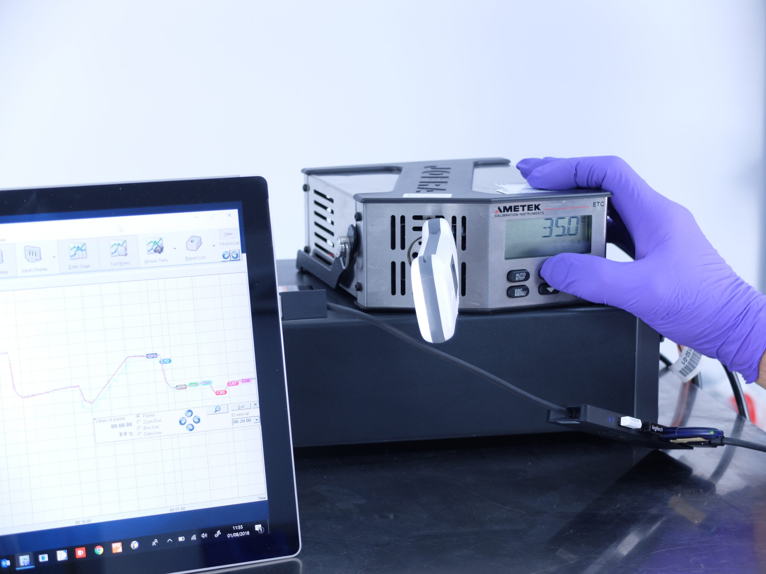 Washer disinfector validation in progress with mointoring equipment and data displayed on screen